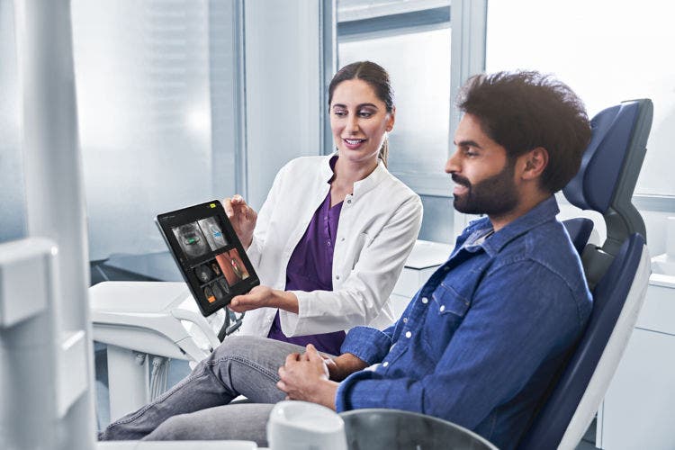 Dentist reviewing digital scans with a patient using DS Core to support diagnosis and treatment planning.