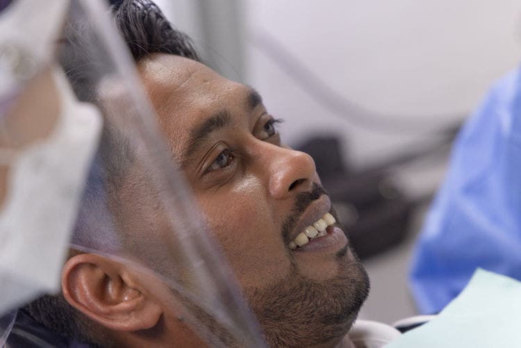 Dentist examining patient's tooth during endodontic diagnostic procedure