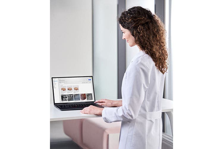 Dental professional reviewing patient data on a laptop using cloud-based dental software DS Core.